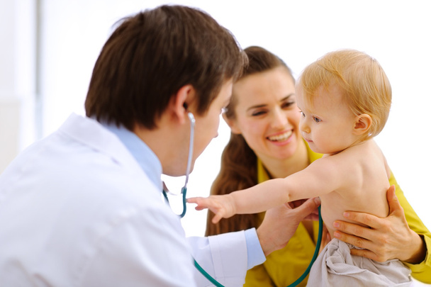 Interested baby stretching for stethoscope while being on examin - Φωτογραφία, εικόνα