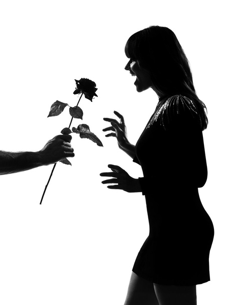 Stylish silhouette man hand offering a flower rose - Foto, afbeelding
