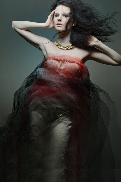 Young fashion model wearing designer dress. - Foto, Imagem