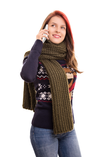 Portrait of a young girl in winter clothes talking on a phone - Фото, зображення