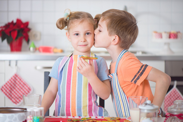 Cute boy and girl preparing Christmas cookies at home - Photo, Image