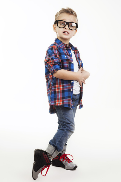 Funny child.fashionable little boy in glasses, jeans, white t-shirt and plaid shirt.stylish kid in sport shoes. fashion children - Zdjęcie, obraz