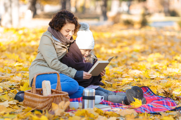 Mother and daughter reading book - Photo, image