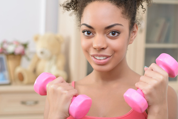 Cheerful girl doing physical exercises - Foto, immagini