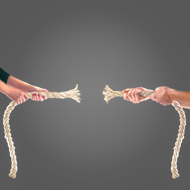 Hands of people pulling the rope on black background. Competition concept - Photo, Image