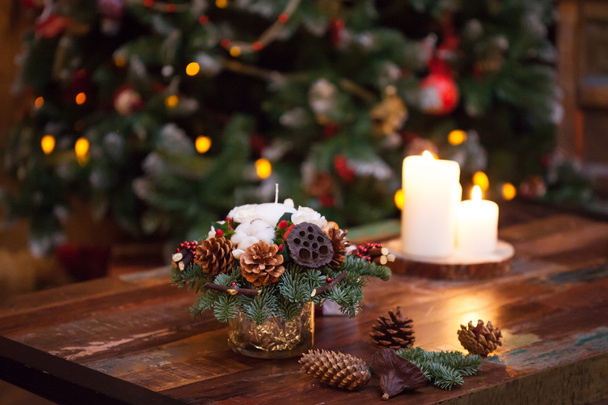 Fir branches decorated for the new year on dark wooden background. Christmas tree and candles, festive mood - Foto, Bild