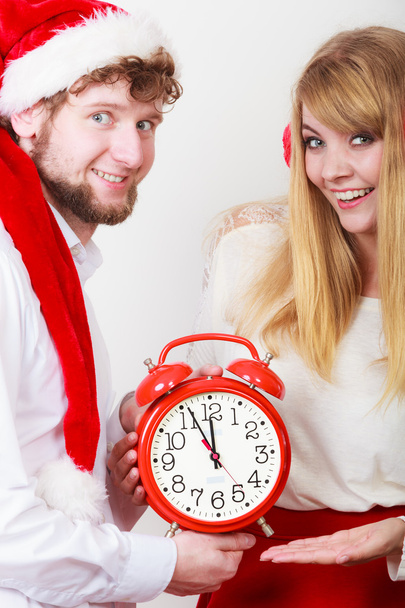 Happy couple woman and man with alarm clock. - Foto, afbeelding