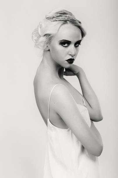 Beautiful blonde in vintage dress on a dark background - Fotó, kép