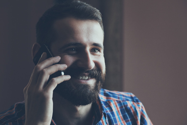 bearded man talking on phone - Photo, image