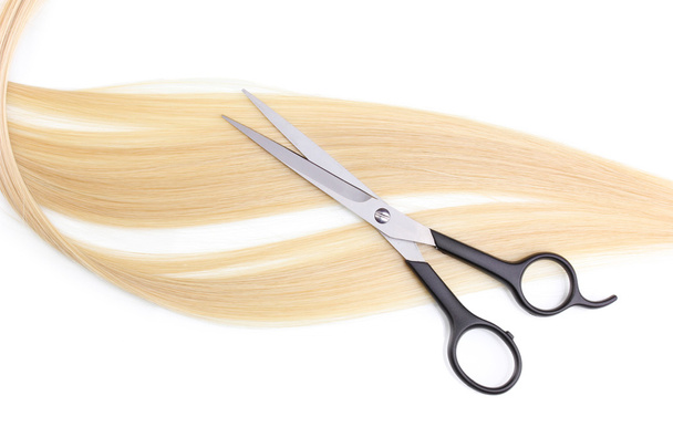 Shiny blond hair and hair cutting shears isolated on white - Fotó, kép