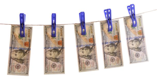 Concept of money laundering - dollars are drying on cord isolated on white background - 写真・画像