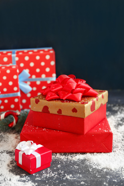 Christmas gifts on color wooden background - Photo, Image