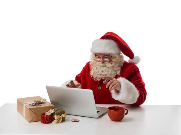 Santa Claus working with laptop - Фото, изображение