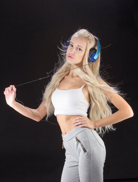 Sexy woman listening for the music using headphones - Foto, imagen