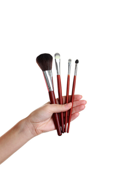 Female hand with brushes for make-up - Fotó, kép