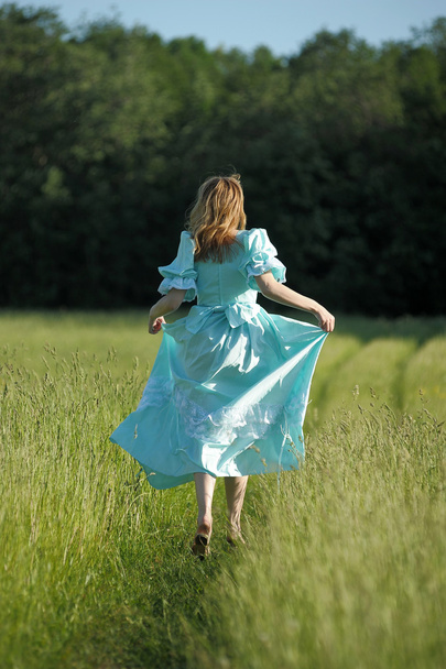 Young woman in an retro dress in the field - Photo, Image