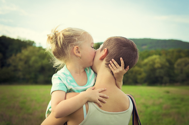 Adorable young girl kissing her mother - Foto, Imagem