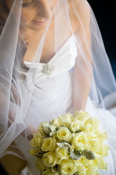 Bride holding her bouquet in lap - Zdjęcie, obraz
