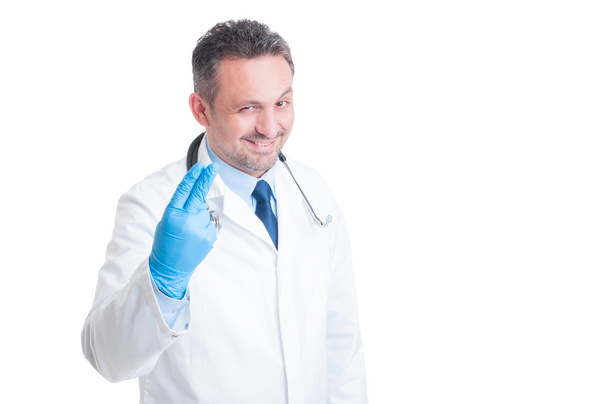 Proctologist showing two fingers with surgical latex gloves - Photo, Image