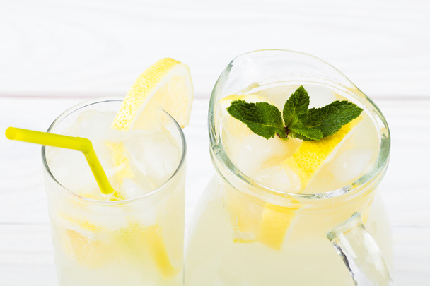 Lemon cocktail with ice and segments of a lemon - Fotó, kép