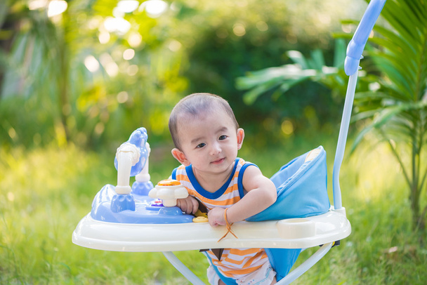Asian baby in the baby walker - Foto, immagini