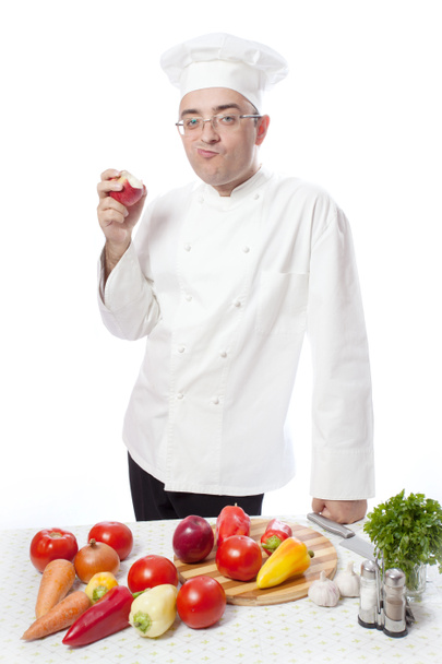 Cook eating red apple - Zdjęcie, obraz