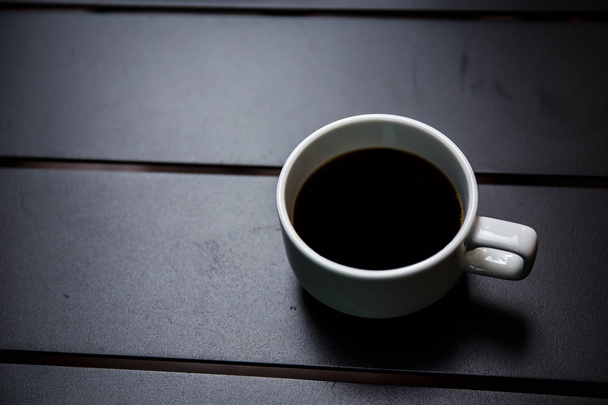 coffee cup on black table - Foto, Imagem