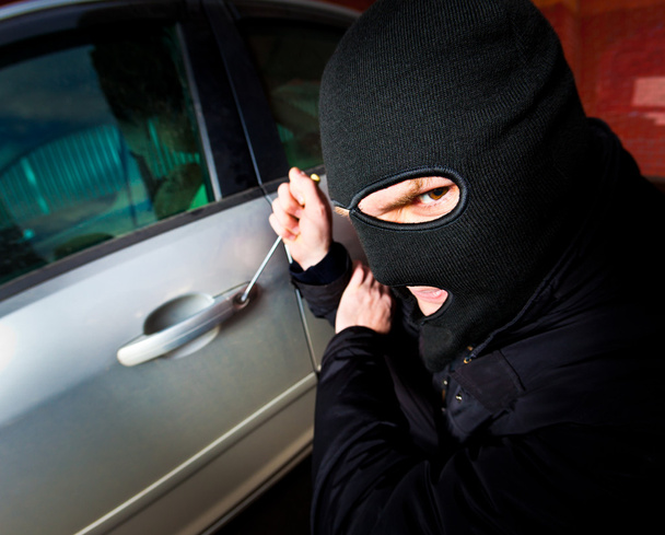 Robber and the thief in a mask hijacks the car - Foto, Imagen
