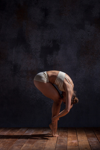 Young beautiful dancer in beige swimwear dancing on lilac background - Foto, Imagem