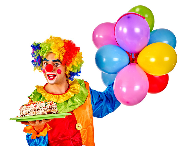 Happy birthday clown holding a bunch of balloons. - Foto, afbeelding