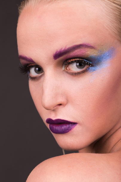 Beautiful model with art makeup on a dark background - Valokuva, kuva