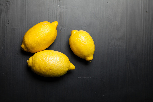 Fresh lemons on wooden table - Fotó, kép