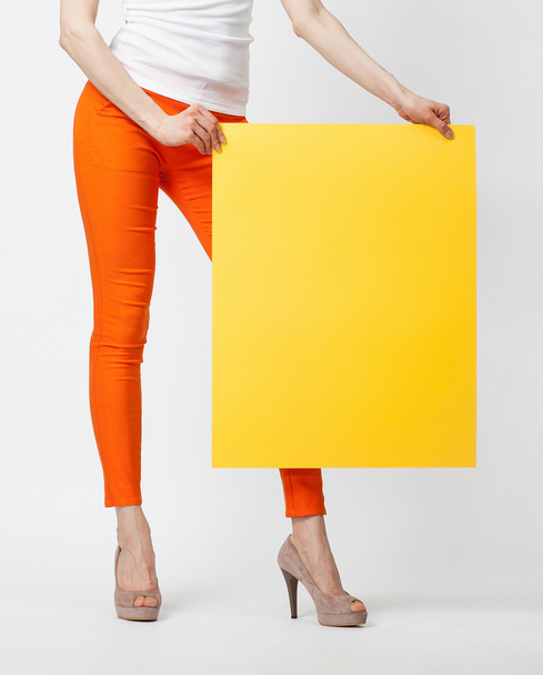 woman holding blank yellow paper - Valokuva, kuva