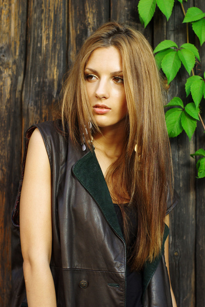 Fashion shot of a beautiful model posing at the vineyard wall - Photo, Image
