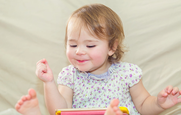 Happy toddler girl playing with her tablet computer  - Φωτογραφία, εικόνα
