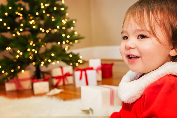 Toddler girl smiling in front of the Christmas tree - Foto, Imagem