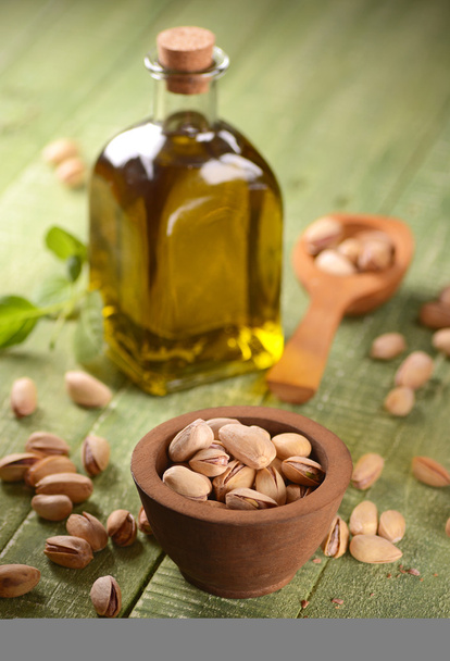 pistachio oil in the bottle - Фото, изображение