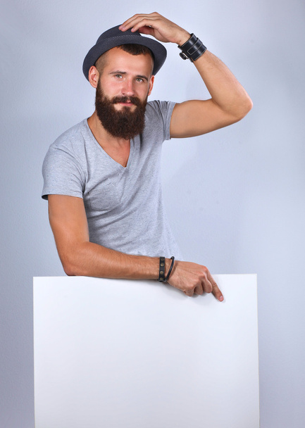 Portrait of young man in hat standing near blank, isolated on white background - Φωτογραφία, εικόνα
