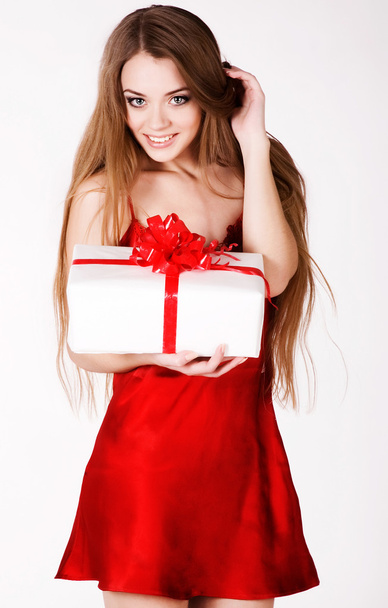 A beautiful young girl with a big gift - Zdjęcie, obraz
