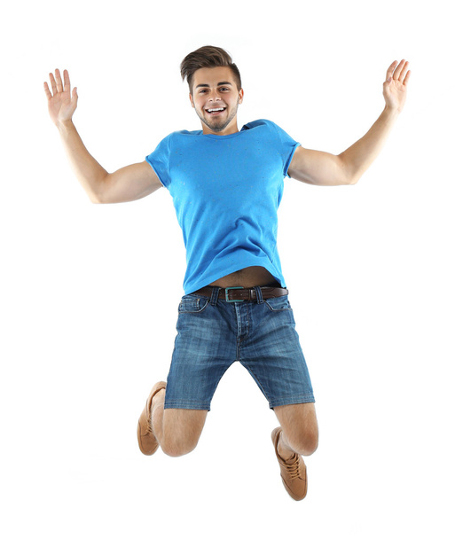 Active guy jumping in joy - Фото, изображение