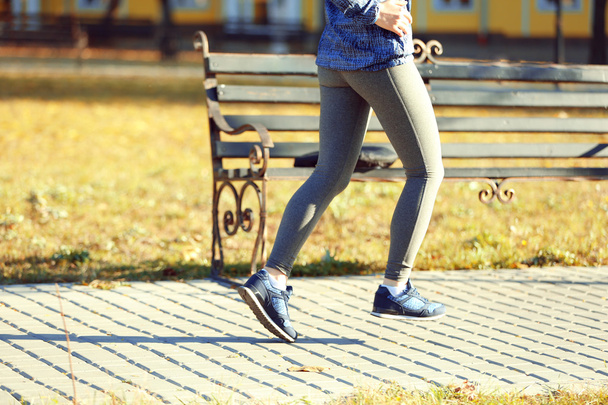 Young woman jogging at park - 写真・画像