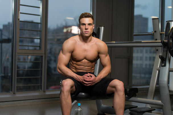 Attractive Young Man Resting Relaxed In Gym - Foto, afbeelding