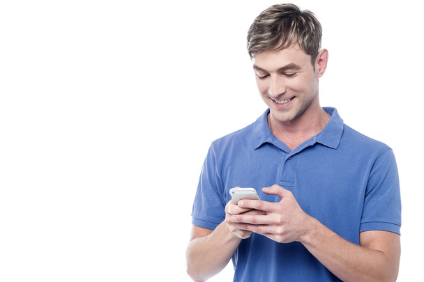 young guy busy on mobile phone - Photo, Image