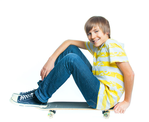 Blond boy on sitting on skateboard - Foto, immagini
