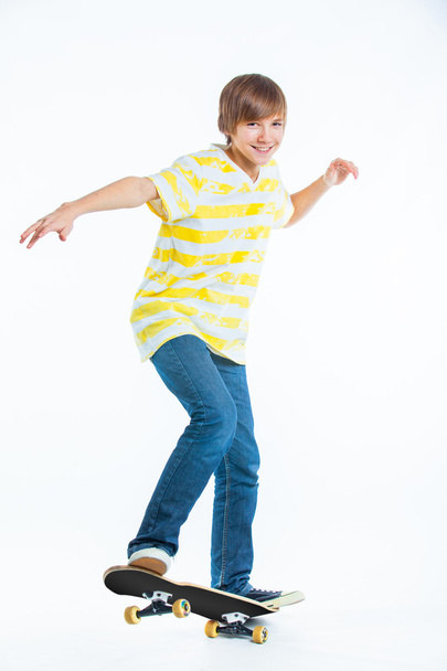 Blond boy on standing on skateboard - 写真・画像