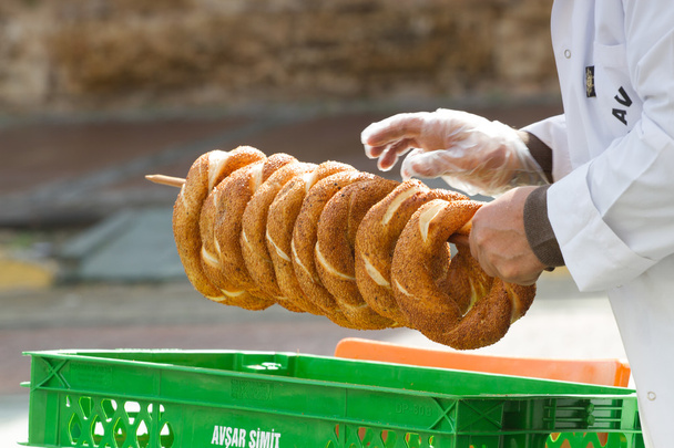 The hand that holds a bunch cook bagels. Round donuts. Antalya - Photo, Image