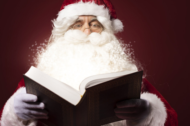 Santa Claus reading book - Фото, изображение