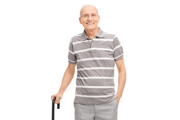 Senior man holding a cane and posing - Foto, Imagem