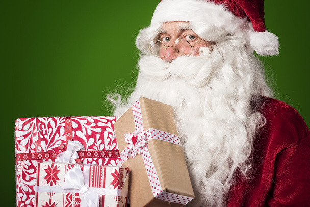 Santa Claus with pile of presents - Photo, Image