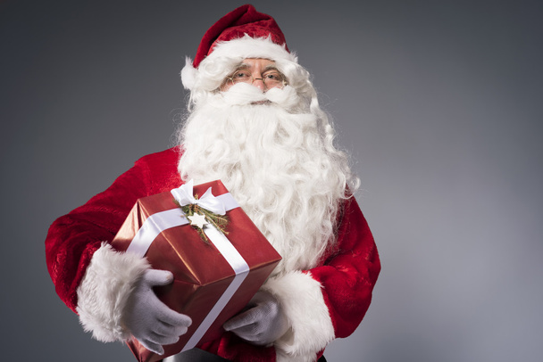 Santa Claus drží dárkovou krabici - Fotografie, Obrázek